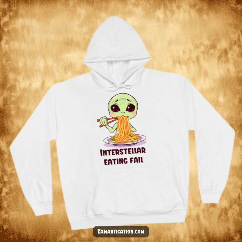 Funny Hoodie illustration of a confused alien attempting to eat spaghetti with chopsticks, exuding warmth and a quirky, cosmic vibe.