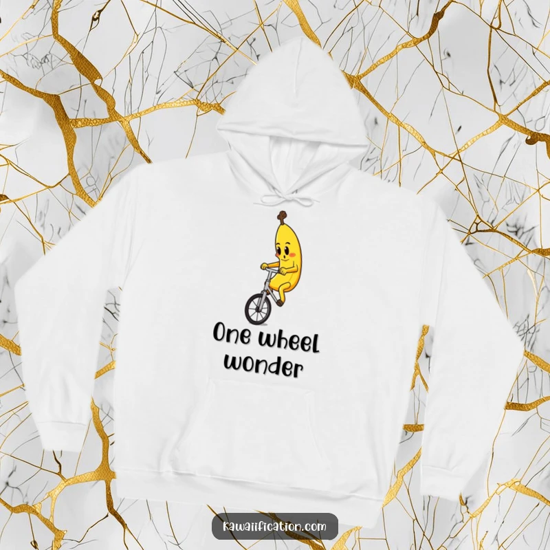 Funny hoodie featuring a determined banana character hilariously attempting to ride a unicycle, perfect for cozy, humorous wear.
